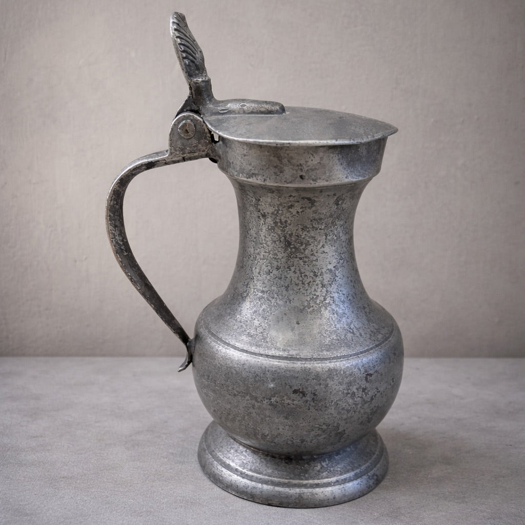 Vintage silver pitcher on a neutral background