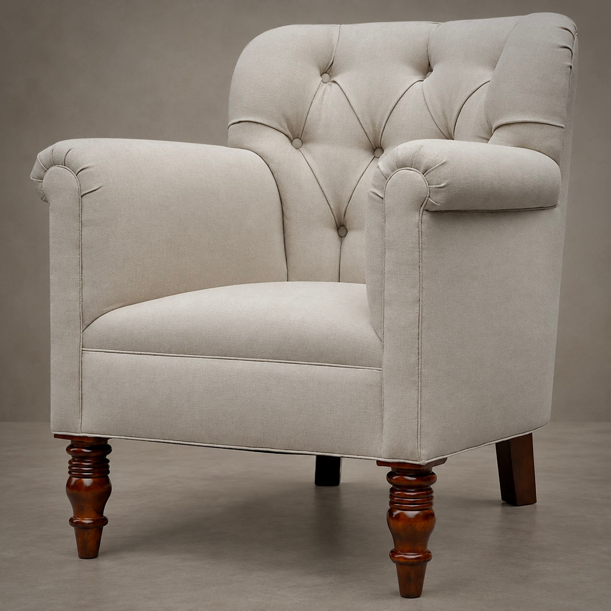 A classic tufted armchair with cream-colored fabric upholstery and turned dark brown wooden legs, shown against a neutral gray studio background.