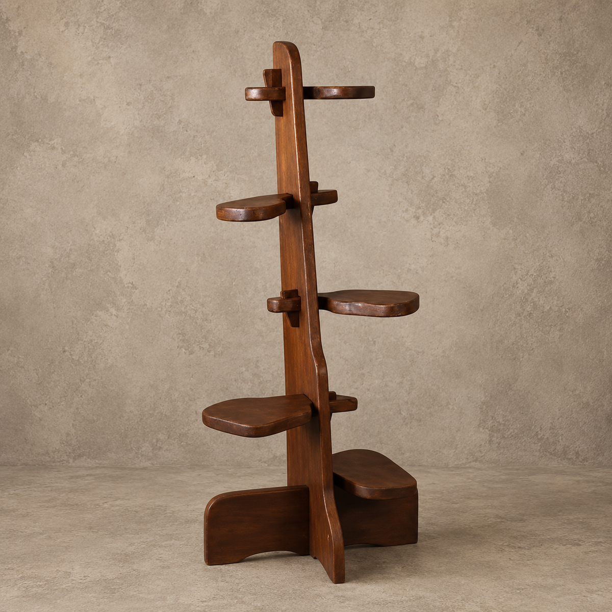 A dark brown wooden multi-tiered shelf stand with curved, organic-shaped platforms, photographed against a textured beige studio backdrop.