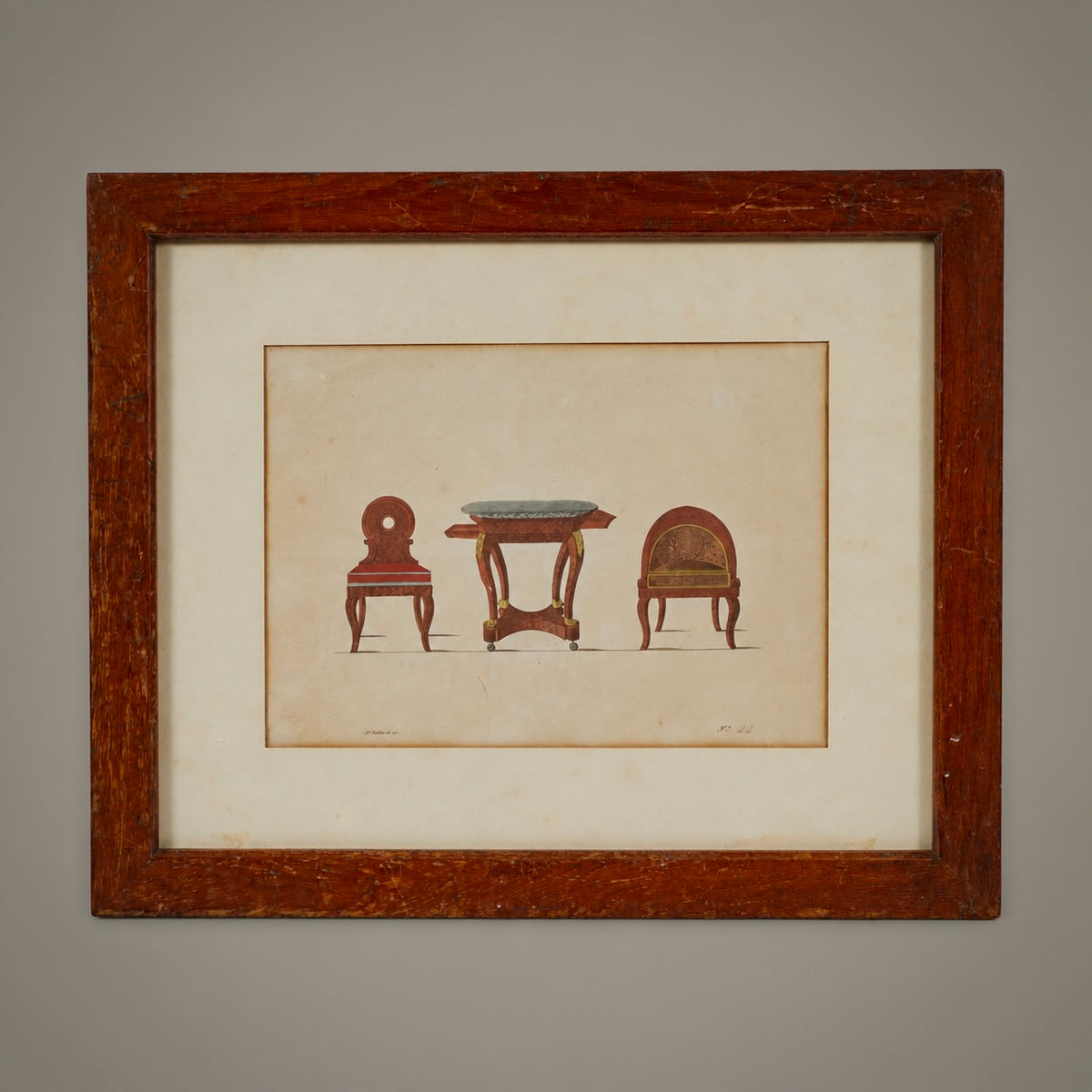 A framed art print featuring a vintage illustration of three wooden furniture pieces: a chair, a small table, and another chair, set against a warm beige background with a dark brown wooden frame.