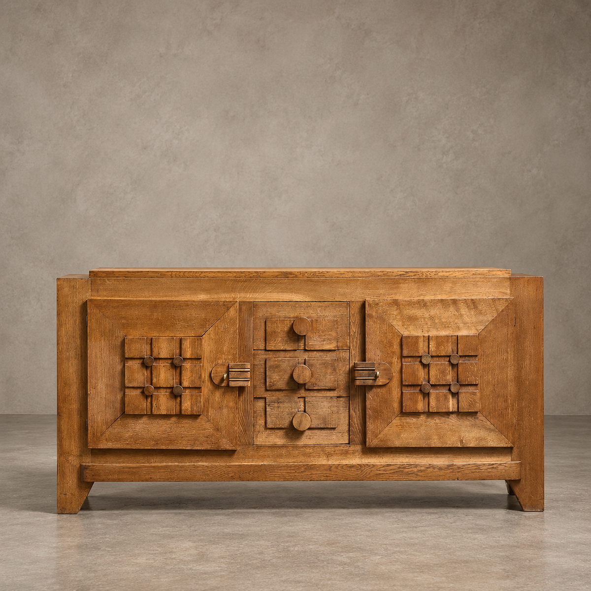 A mid-century modern wooden sideboard with geometric carved details and a warm medium-brown finish, set against a textured gray studio background.