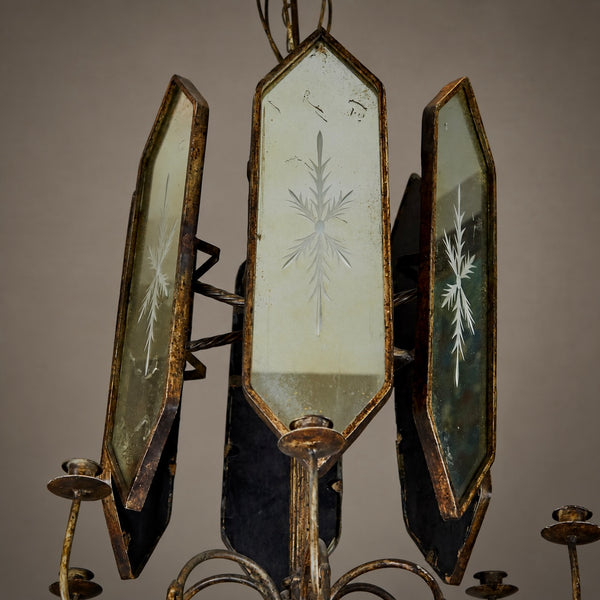 An antique three-light chandelier featuring distressed bronze metal frames and etched glass panels with snowflake-like patterns, shown against a neutral background.