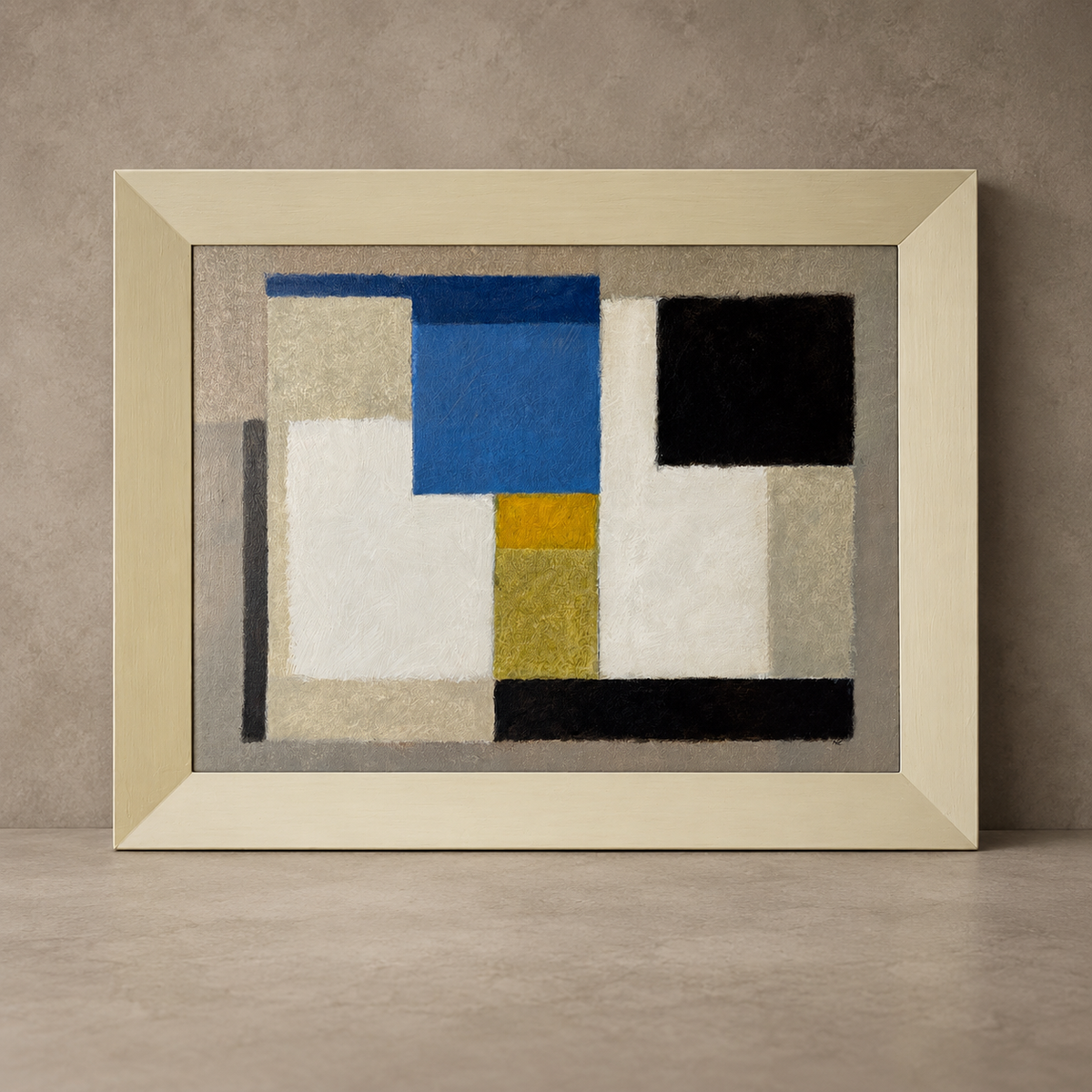 A framed abstract geometric painting with blocks of blue, black, white, and mustard yellow on a gray background, set in a light wood frame and leaning against a textured gray wall.