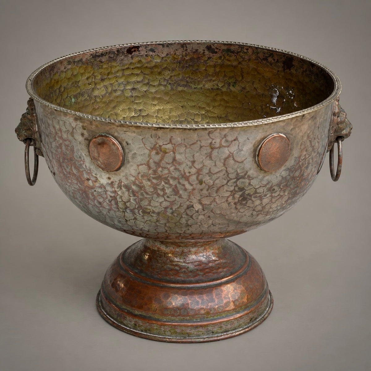 Hammered silver and copper urn displayed on a white background.