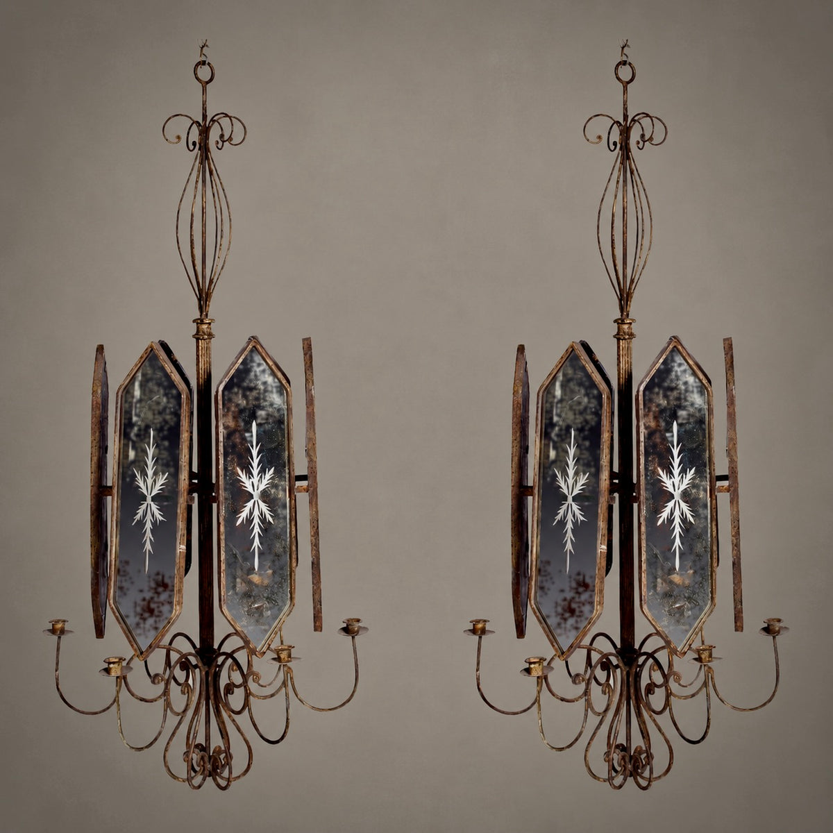 A pair of vintage industrial-style wall sconces with distressed bronze metal frames, mirrored glass panels featuring etched snowflake patterns, and five candle-style arms each.