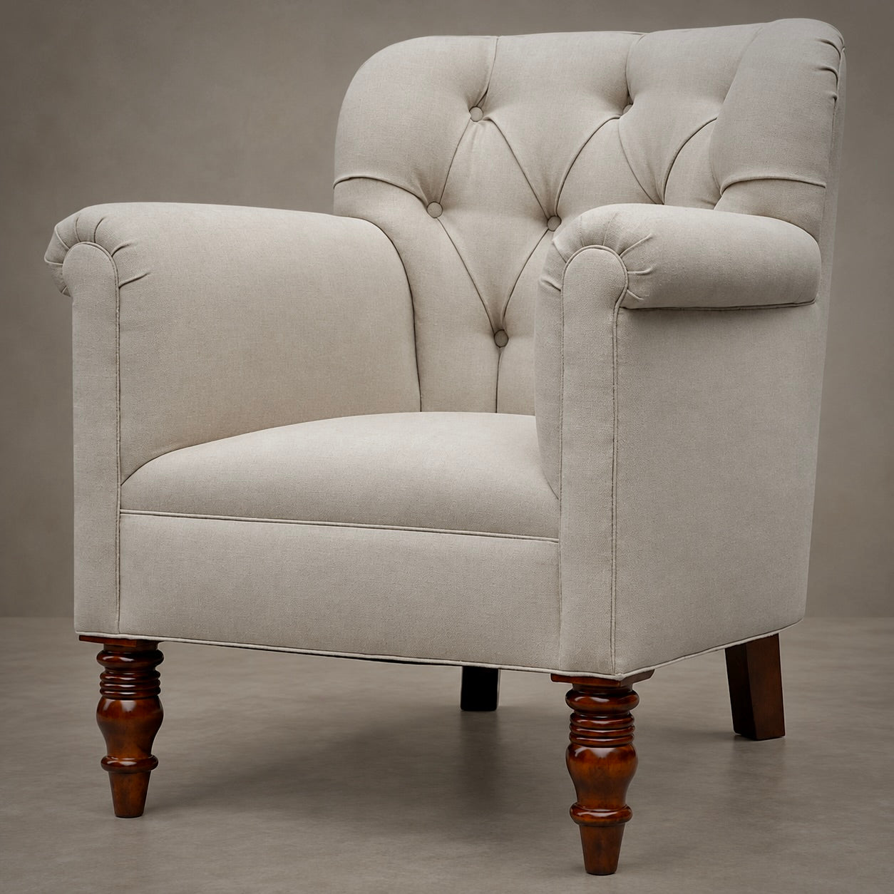 A classic tufted armchair with cream-colored fabric upholstery and turned dark brown wooden legs, shown against a neutral gray studio background.