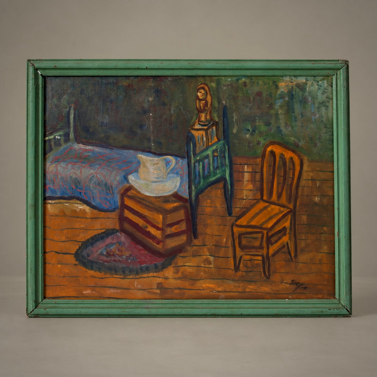 A framed oil painting depicting a rustic bedroom interior with a bed, chair, and wooden chest, enclosed in a distressed green frame and photographed against a neutral gray background.