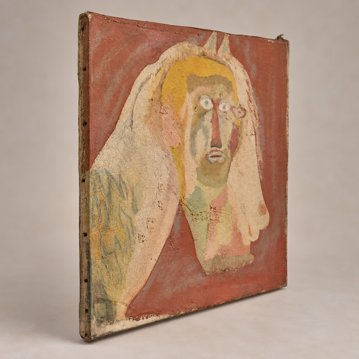 A hand-painted canvas painting depicting a stylized face against a reddish-brown background, shown at an angle on a neutral studio background.