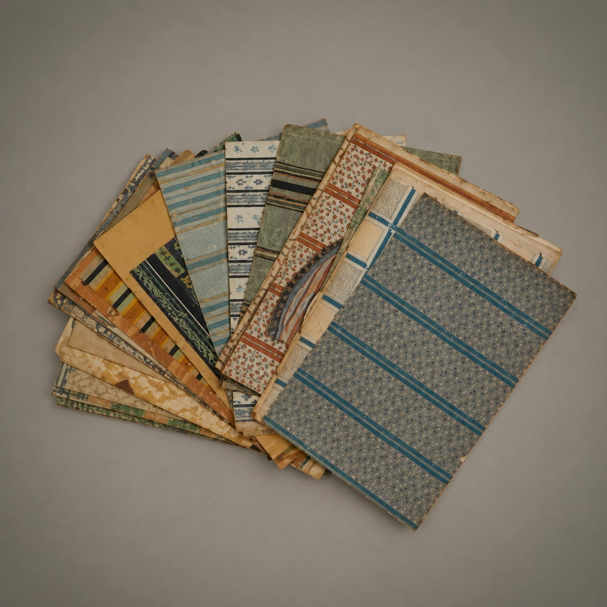 A collection of vintage-style wallpaper samples with various patterns and muted colors.