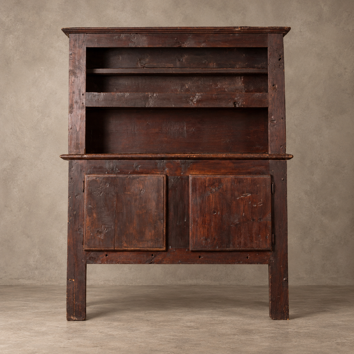A dark rustic wooden hutch or cabinet with two upper shelves and two lower doors, photographed against a neutral textured beige studio backdrop.