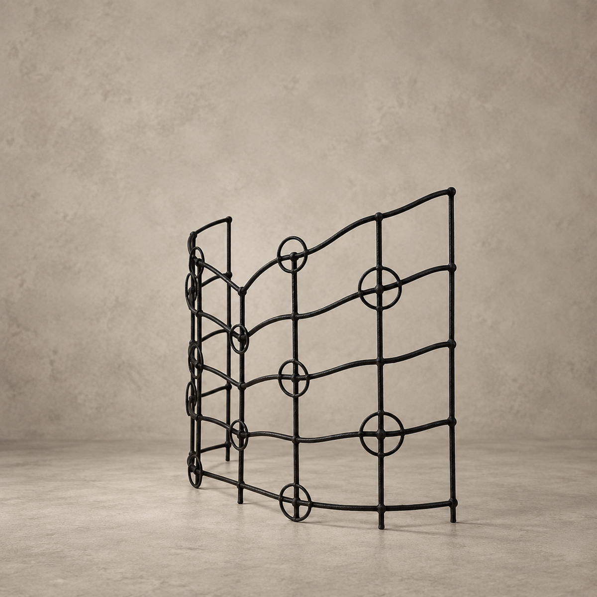A black metal wine rack with a wavy, modern design and circular accents, standing on a concrete floor against a textured concrete wall.