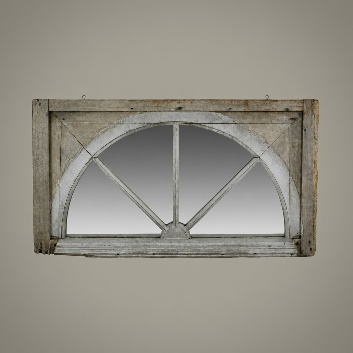 A rustic rectangular wall mirror with an arched window design, featuring a distressed gray and brown wooden frame with decorative crossbeams.