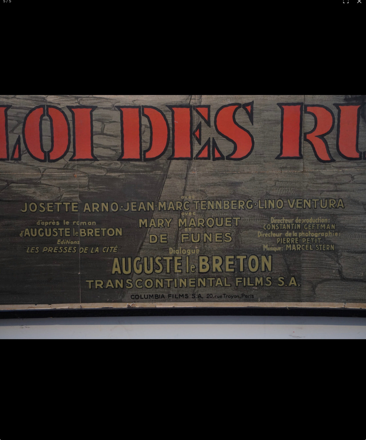 A vintage movie poster for the film 'Loi des Rivières' featuring cast names including Josette Arno, Jean Marc Tenberg, and Lino Ventura, printed on a dark textured background with bold red and gold lettering.