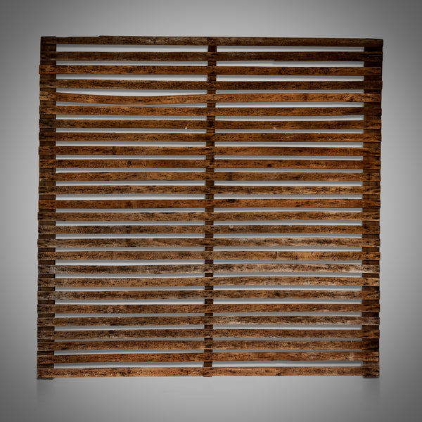 A multi-slatted wooden panel with a rustic finish, vertically oriented, displaying the grain and texture of the wood.